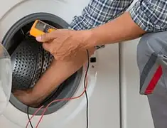 Washing machine repair technician testing a front-load washer with diagnostic tools in St Paul, MN